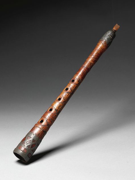 WOOD AND PEWTER INSTRUMENT, PROBABLY EASTERN WOODLANDS      of expanding oval section, drilled with a series of five holes on the front, overlaid at each end with pewter decoration; a small mouthpiece inserted at one end.  length 15 1/8 in. Indian Musical Instruments, Wooden Flute, Eastern Woodlands, Native American Traditions, Native American Flute, Flute Music, First Peoples, Native American Artifacts, Old Music