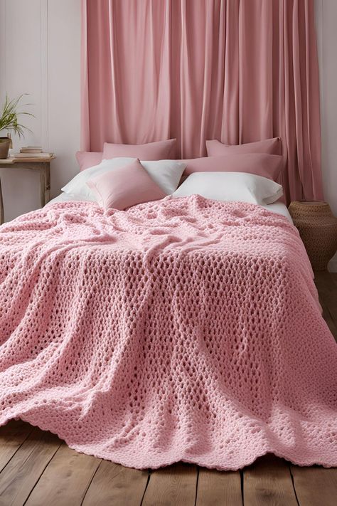 A bedroom scene with a large, soft pink crocheted blanket draped across a bed, complemented by white bedding and curtains. Easy Crochet Blanket Patterns, Cozy Crochet Blanket, Crochet Blanket Ideas, Handmade Blankets, Velvet Throw Blanket, Cables Blanket, Tassel Blankets, Chunky Crochet Blanket, Crochet Blanket Pattern Easy