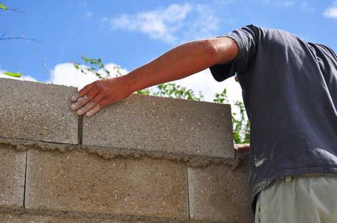 Learn how to cover exterior cinder block walls and improve the look of your home's exterior. We provide step-by-step guidance and tips for a successful job. Cinder Block Foundation, Homestead Plans, Painting Concrete Walls, Cinder Block House, Stone Veneer Wall, Concrete Pigment, Successful Job, Concrete Block Walls, Cinder Block Walls