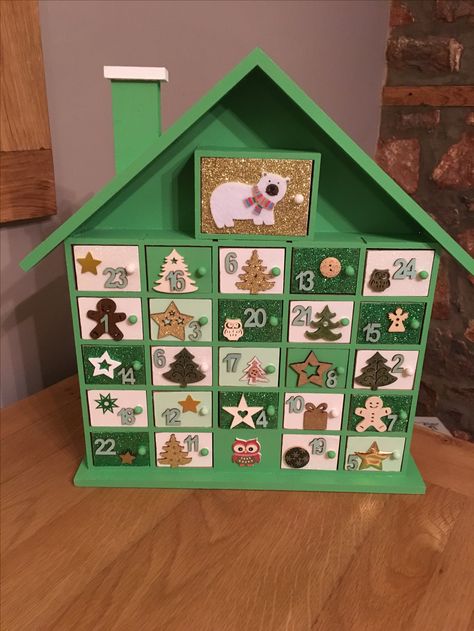 Hand painted Advent Calender. I started with a blank Calendar bought from Hobbycraft and decided to paint it green and white as it was for a boy, I’m really pleased how it turned out 😊 Hobbycraft Advent Calendar, Paint Your Own Advent Calendar, Painted Advent Calendar Ideas, Painted Wooden Advent Calendar, Hand Painted Advent Calendar, Painted Advent Calendar, Advent Calendar House, Advent House, Christmas Tree Advent Calendar