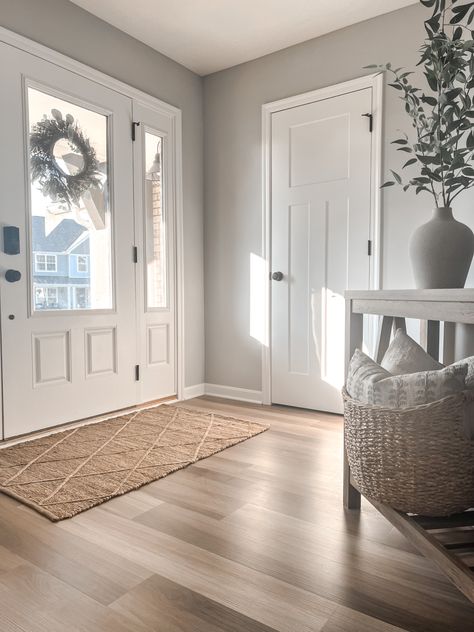 Entryway, foyer, hallway, console table, indoor rug, jute rug, front door, vase styling, summer decor, SW zircon gray, LVP flooring Rug Inside Front Door, Large Entryway Rug Ideas, Front Door Inside Rug, Front Door Indoor Rug, Front Door Rugs Indoor Entryway, Front Door Indoor Rug Entryway, Inside Front Door Rug, Indoor Rugs Front Doors, Indoor Front Door Rug