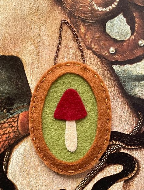 I made this miniature wall hanging with beautiful merino wool felt in earthy tones, creating a faux frame with a sweet little mushroom and a chain. Only one is available. It would make a perfect addition to a gallery wall with a small empty space to ill measures approximately 4" x 2"  (length is hanging with the chain)