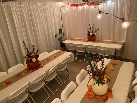 I decided to host Thanksgiving for about 15 people in my 1300 sq ft home. Being limited on space I decided to convert the garage into an extended dinning room. This setting was for 20 people. I rented the pipes and drapes, tables and chairs. It was expensive but definitely saved me time from doing it myself. It is however, totally doable on your own. With the addition of some decorations and lights it converted the space into a beautiful and elegant setting. Dinner Table Thanksgiving Decor, Thanksgiving Garage Decorations, Thanksgiving Table Settings For 20 People, Thanksgiving Dinner Outfits 2023, Dinner Party For 20 People Table Settings, Thanksgiving Dinner Centerpieces Diy, Thanksgiving Dinner Set Up Ideas, Thanksgiving Party Decorations Diy, Thanksgiving Dinner Table Set Up