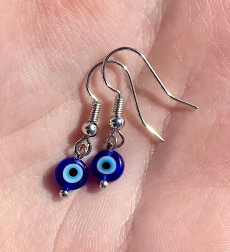 Dainty, handmade, evil eye, glass bead earrings with silver or gold earring hooks, posts, or hoops. All of my jewelry is hypoallergenic and waterproof. Handmade Evil Eye, Glass Bead Earrings, Evil Eye Earrings, Eye Glass, Dope Jewelry, Funky Jewelry, Eye Earrings, Hippie Jewelry, Dangly Earrings