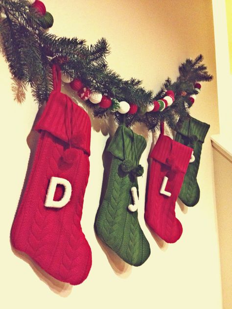 No fireplace? Hang up stockings on empty wall with command strips, then cover up the command strips with a garland ✔️ Christmas Stocking Wall Decor, Hang Stockings In Apartment, Stocking Hanging Ideas Wall, Stocking On The Wall, Wall Hanging Stocking Ideas, Christmas Stocking Wall Hanger, Christmas Stocking On Wall, Stockings Hung On Wall, Stocking Wall Ideas