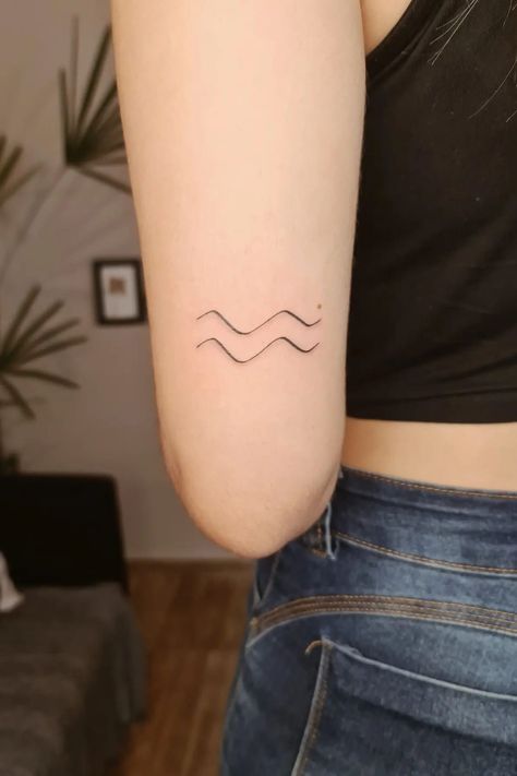 32 Simple and Beautiful Aquarius Tattoos Aquarius Tattoo Glyph, Aquarius Glyph Tattoo, Fine Line Aquarius Tattoo, Aquarius Wave Tattoo, Zodiac Tattoos Aquarius, Aquarius Minimalist Tattoo, Tattoo Ideas Aquarius, Small Aquarius Tattoo, Aquarius Tattoo Designs For Women