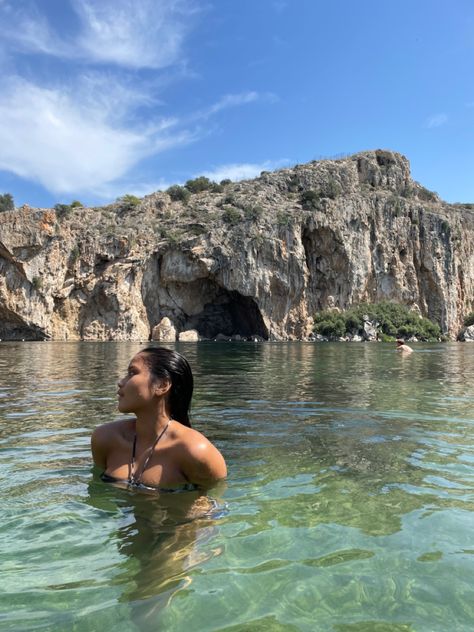 girl looking to the side, dipped into a lake with beautiful rock formation as her background Lake Pic Inspo Aesthetic, Lake Dip, Lake Instagram Pictures With Friends, Lake Poses Instagram Bikinis, Lake Vouliagmeni Athens, Aesthetic Lake Pictures With Friends, Lake Vouliagmeni, Fall Vacation, Boat Pics