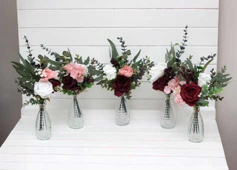 These chic wedding centerpieces blend classic elegance with a modern twist. Featuring rich burgundy, delicate blush, and crisp white florals, accented by lush greenery, they’re perfect for adding a touch of sophistication to your special day. 🌸🌿✨ #centetpieces #tabledecor #tableflowers #weddingarrangement #weddingflowers #burgundywedding #fauxflowerarrangement #artificialflowers #weddindflorist #weddingvendor Burgundy Flower Centerpieces, Burgundy And Blush Wedding Flowers, Bouquet Fall Wedding, Ivory Bouquet, Faux Bouquet, Mini Bouquets, Burgundy And Blush Wedding, Blush Wedding Flowers, Faux Flower Arrangements