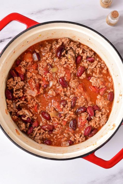 Easy Dutch Oven chili recipe you can make with 5 ingredients or go all out with our homemade blend of ground beef or sausage and beans. Chili Recipe Dutch Oven, Best Chilli Recipe, Dutch Oven Chili Recipe, Recipe Dutch Oven, Best Slow Cooker Chili, Dutch Oven Chili, Pressure Cooker Beans, Chili Recipe Stovetop, Slow Cooker Chili Easy