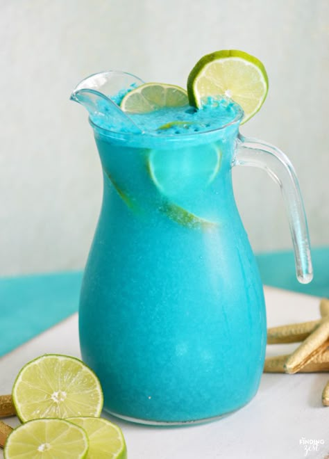 Throwing an mermaid, pool or ocean themed party? This Mermaid Punch recipe is quick and delicious featuring tropical flavors! Your guests will love this blue pina colada punch! Blue Pina Colada, Mermaid Punch, Pina Colada Punch, Blue Punch Recipe, Ocean Themed Party, Tropical Mermaid, Shower Punch, Tropical Drink Recipes, Party Punches