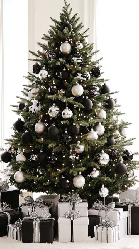 Elegant Christmas tree adorned with black and white ornaments and silver ribbons, surrounded by matching wrapped gifts. Black And Silver Christmas Tree, White And Black Christmas Tree, Black And White Ornaments, Black And White Christmas Decor, Black White Christmas Tree, Black And White Christmas Tree, White Christmas Decor Ideas, Glam Christmas Tree, Scandinavian Christmas Trees