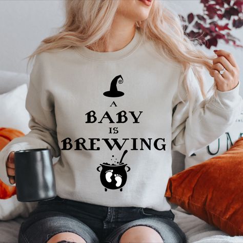 Show off your soon to be spooky surprise in this cozy Halloween Maternity Sweatshirt letting everyone know a baby is brewing! This is perfect for a pregnancy announcement or a comfortable maternity Halloween costume! Maternity Halloween Costume, A Baby Is Brewing Halloween, Maternity Halloween, Halloween Maternity, Halloween Pregnancy Shirt, Halloween Pregnancy Announcement, Pregnant Halloween Costumes, A Baby Is Brewing, Baby Is Brewing