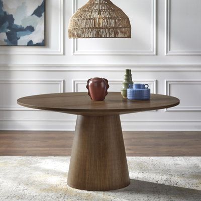 This modern round dining table brings a touch of sophistication to your dining space. With a pedestal base made from solid wood, this table adds a contemporary flair to your room. The top is crafted from engineered wood. Seating up to six guests, this table is perfect for intimate gatherings or family dinners. Weighing in at 100 lbs. it offers stability without compromising on style. Wade Logan® Color: Walnut | Wade Logan® Boudot Pedestal Dining Table black / brown / grayWood in Walnut | 30.75"… Round 60 Inch Dining Table, 42 Inch Round Dining Table, 60 Inch Round Dining Table, Modern Round Dining Table, Round Dining Table Modern, Wood Seating, Brown Home Decor, Dining Table Black, Pedestal Dining Table