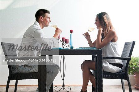 couple+sitting+at+table | Couple sitting at table drinking white wine Stock Photo - Premium ... Sitting At Table Drawing Reference, Table Pose Reference, Couple Sitting At Table, Sitting At Table, Couple Sitting, Figure Poses, People Sitting, Pose Reference Photo, Cool Art Drawings