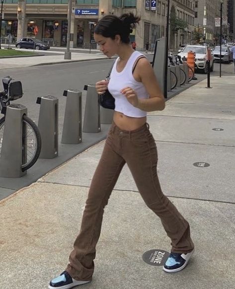 white cropped tank top paired with low waisted brown jeans, a black shoulder bag or baguette purse, and air jordan 1 retros unc patent leather, pinned up hairstyle #hair #hairstyles #purse #brown #outfits #outfitideas #fashion #sneakers #jeans #cropped Bekväma Outfits, Vestiti Edgy, Looks Pinterest, Brown Jeans, Populaire Outfits, Brown Outfit, Looks Street Style, Modieuze Outfits, Streetwear Fashion Women