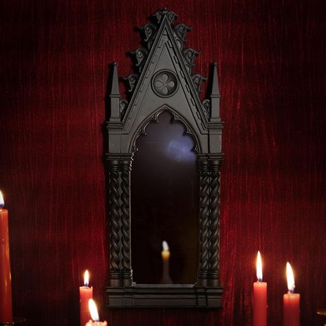 The Odette Gothic Cathedral Mirror for wall hanging. This elegant mirror, inspired by Gothic architecture, features a black ornate frame in the shape of a cathedral. Bring intrigue and sophistication to any room with this captivating piece. Complete with a hook on the reverse for wall hanging  Dimensions: H: 41cm W: 15cm D: 3cm Skeleton Lamp, Spine Candle, Cathedral Mirror, Blackened Teeth, Gothic Manor, Cat Candles, Black Pillar Candles, Gothic Wall Decor, Gothic Candles