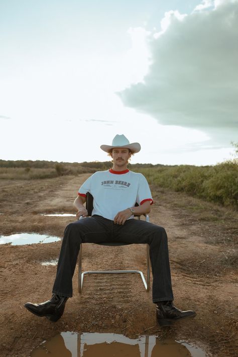 Cowboy-sitting-in-chair-in-front-of-puddle Cowboy Men Outfit, Cowboy Editorial, Hipster Cowboy, Cowboy Outfit Men, Urban Cowboy Style, Cowboy Men, Mens Western Wear, Modern Cowboy, Cowboy Aesthetic