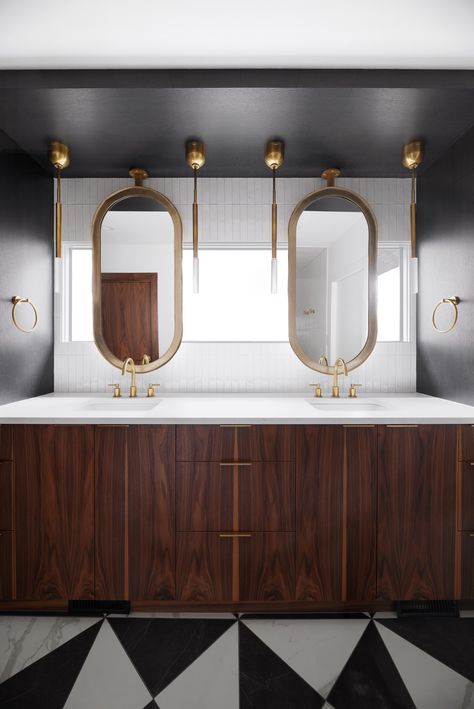 black and white tile, floor tile, mirror, vanity, bathroom design, bathroom vanity, gold accents, faucets, maple cabinets, bathroom design, ceiling hung mirror, black walls, geometric tile