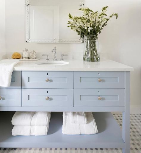 Fitted with a towel shelf, a cornflower blue washstand is accented with nickel hardware and a polished nickel hook and spout faucet mounted under a Venetian mirror. Light Blue Bathroom, Blue Bathroom Vanity, Beautiful Bathroom Designs, Modern Coastal Decor, Blue Vanity, Miami Houses, Coastal Bathrooms, Beautiful Dining Rooms, Blue Cabinets