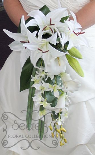 Our in house floral designs are mocara orchids, and freesia for mid toned purple, vanda orchids, dendrobium orchids An orchid bouquet made exclusively of puerple dendrobium flowers is very hip. Description from weddingacce.net. I searched for this on bing.com/images Stargazer Lily Wedding Bouquet, Stargazer Lily Wedding, Orchid Bridal Bouquets, Lily Bridal Bouquet, Cascading Wedding Bouquets, Lily Wedding, Dendrobium Orchids, Stargazer Lily, Cascade Bouquet