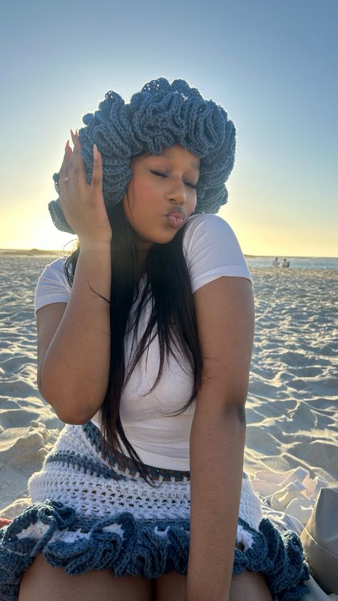 Girl wearing blue and white chelly crotchet hat and frilly blue and white crotchet skirt with a white top on the beach with almond nails and black hair . Chelly Crochet Hat, Beach Crochet Hat One Size, Cream Crochet Beach Hat One Size, Cute Brimmed Crochet Beach Hat, One-size Crochet Hat For The Beach, Crotchet Hat, Ruffled Crochet Beach Hat, One Size Fits Most, Beach Fit, Crochet Crown