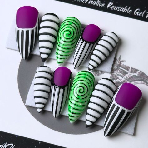 Creepin’ it real with Beetlejuice vibes! These nails are more fabulous than a sandworm on a catwalk. 🪲🖤 Beetle WHAT!? On Après Medium Stiletto 💅🏻 ⁣ .⁣ .⁣ .⁣ .⁣ .⁣ #timburton #spookyseason #beetlejuicenails #purplenails #beetlejuiceedit #halloweennailart #beetlejuice #handpaintednails #nailsnailsnails #halloweennails #nailart #beetlejuicecosplay #timburtonnails #spookynails #halloweencostume #gothaesthetic #gothnails #nailartist #freehandnailart #beetlejuicebeetlejuicebeetlejuice #halloweenev... Beetlejuice Nails, Creepin It Real, Medium Stiletto, Goth Nails, Gel Press, Alternative Style, Hard Gel, Goth Aesthetic, Halloween Nail Art