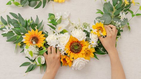 Sunflower floral swags are an organic way to brighten up your day. It honestly couldn’t be merrier for the lovebirds to exchange vows in front of a sunflower-inspired archway filled with love, joy and personal touches.Here we made a set of asymmetrical arch swags, the lush one measuring 36” long x 10 Sunflower Arch, Diy Sunflower, Sunflower Wedding Decorations, Floral Swags, Diy Wedding Arch, Wedding Swag, Sunflower Arrangements, Sunflower Themed Wedding, Sunflowers And Daisies