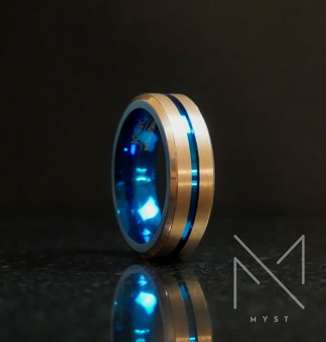 Discover a unique blend of color and durability with our Blue and Gold Tungsten Men's Wedding Band. This stunning ring features a vibrant blue interior and dual gold-tone stripes on the exterior, creating a bold and modern look. * R I N G ∙ D E T A I L S * › 1x Men's Wedding Band › Width: 8mm › Material: Tungsten Carbide › Finish: Brushed exterior wi...#World #Expression #Elevating #HandmadeJewelry #the #JewelryDesign #JewelryAddict #Exploring #Fashion #Gemstone #Jewelry #of #Style #and #Mens Mens Wedding Bands Blue, Topaz Wedding Ring, Traditional Wedding Bands, Gold Color Combination, Wedding Band Unique, Mens Wedding Bands Tungsten, Tungsten Mens Rings, Ring For Men, Blue Interior