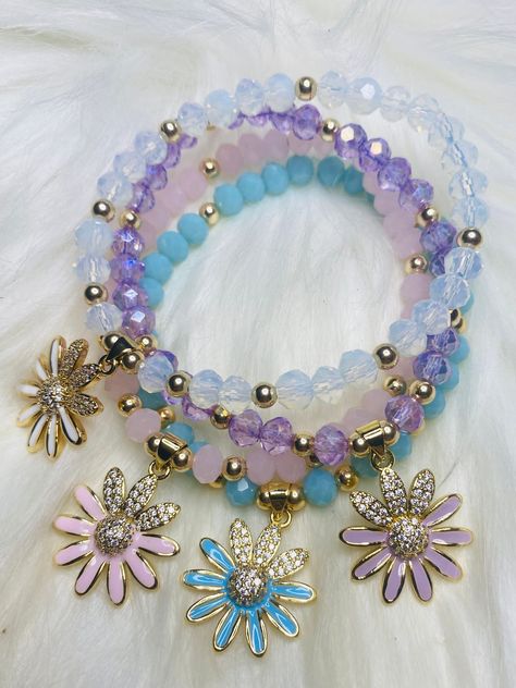 New spring collection. These beautiful daisy bracelets come in eight different colors. They all come with 14 K gold filled beads and With a gold plated rhinestone Daisy charm.you can choose from. orange, purple, pink , yellow , red , whit , blue and teal.  Please allow 1-3days processing time when you purchase, as each piece is made especially for you. These make perfect gifts for moms, grandmas, sisters, brides to be, bridesmaids, girls, baby shower, graduations, birthdays, bachelorette party, best friends, teachers... the list never ends :)  How to care for your bracelets:  *Remove before showering or swimming, avoid water when washing hands *Treat jewelry gently & with special care *Roll onto wrist instead of stretching open  *Do not leave out in direct sunlight Daisy Bracelets, Spring Bracelets, Gifts For Easter, Crystal Bead Jewelry, Easter Jewelry, Spring Bracelet, Fancy Jewellery Designs, Daisy Bracelet, Wrist Jewelry