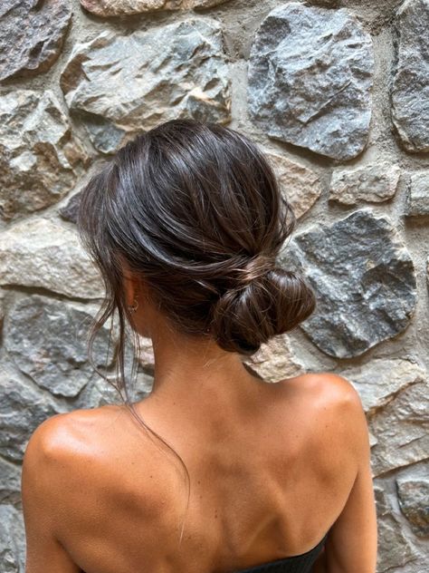 Low Bun With Loose Curls, Prom Simple Updos, Dark Hair Low Bun, Undone Bun Wedding, Prom Updos Simple, Simple Wedding Hair Bun, Low Messy Bun Brown Hair, Minimal Bridesmaid Hair, Simple Bun For Wedding