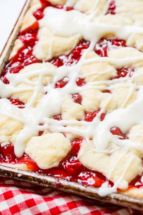 It's like a slab pie! A delicious sugar cookie-like crust with cherry pie filling and then dollops of crust all over the top and finished off with a glaze-this is a sugar cookie sweet cherry pie bars recipe! #cherry #cherrypie #cherrypiebars #dessert #fruitdessert #thanksgivingdessert #4thofjulydessert Cherry Pie Bars Recipe, Cookie Filling, Cherry Slab Pie, Sour Cherry Recipes, Pie Bars Recipe, Cherry Pie Bars, Sweet Cherry Pie, Homemade Cherry Pies, Cherry Topping