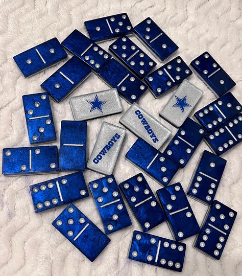 Dallas Cowboys Handmade Dominoes I AM NOT A LICENSED VENDOR  Any team available upon request via personalization section!  If you're going to play, why not make it with your favorite team?  Made with resin, glitter and mica powder with silver  dots. Handmade by me!  Turnaround time is 1-2 weeks but can be sooner! Please message me if you need them sooner and I'll do my best to accommodate! These make the perfect unique and handmade gift. They come in a drawstring bag to keep them together and for easy travel! DISCLAIMER: Due to the nature of resin crafting, all resin products may come with minor imperfections. Colors may vary slightly!   WARNING: DO NOT leave in direct sunlight. Nfl Resin Dominoes, Dallas Cowboys Coasters, Dallas Cowboys Dominoes Resin, Epoxy Dominos, Skye Birthday Party Paw Patrol, Resin Dominoes, Custom Dominoes, Diy Resin Table, Cowboy Crafts