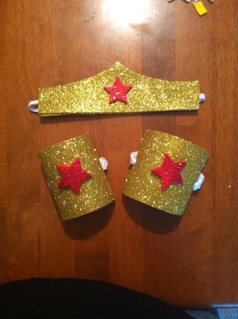 DIY Wonder Woman tiara and bracelets. Tiara: found a template on Pinterest for the shape of the crown. Then traced it onto peel &stick glitter foam sheet, cut it out. Hot glued a piece of felt to the back of the peel and stick (for something soft against the skin) Finally, I took a piece of elastic and hot glued it in between the glitter foam and felt. Bracelets, two toilet paper rolls cut for openings then cut and glued glitter foam sheets to them. Stars are peel and stick glitter foam als... Woman Party Ideas, Wonder Woman Party Ideas, Wonder Woman Tiara, Wonder Woman Costume Diy, Diy Superhero Costume, Diy Fantasia, Wonder Woman Birthday Party, Women Party Ideas, Wonder Woman Party