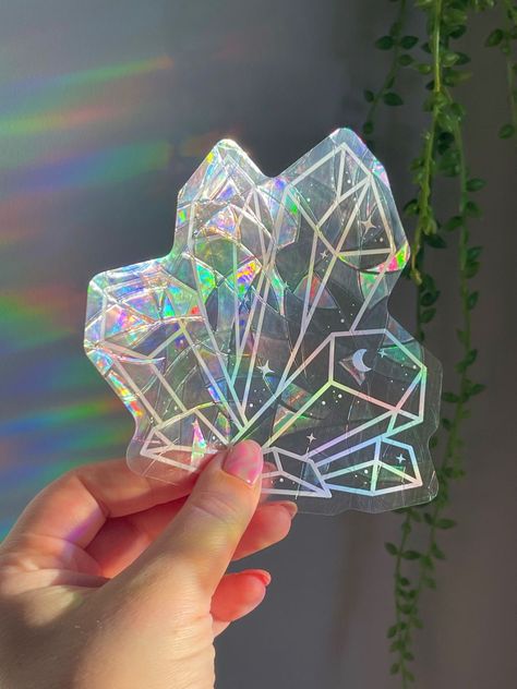 Add a touch of magic to your windows with these holographic suncatcher stickers! They'll create a beautiful rainbow effect when the sun shines through them. #suncatcher #windowdecor . #Cricut_Suncatcher_Sticker #Holographic_Decor #Witchy_Store #Suncatcher_Stickers Witchy Store, Suncatcher Stickers, Suncatcher Sticker, Cricut Stickers, Jewelry Packaging Design, Diy Suncatchers, Crystal Stickers, Holographic Stickers, Rainbow Maker