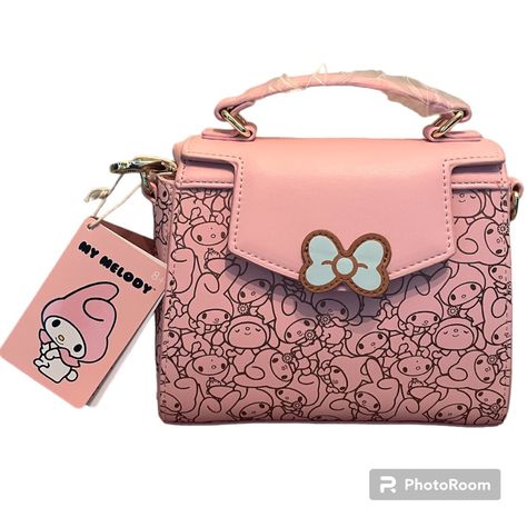 Loungefly Sanrio My Melody Allover Print Handbag My Melody’s Ready To Bring A Super Cute Touch To Your Style As The Allover Print Of This Loungefly Handbag! The Adorable Sanrio Rabbit Appears With Various Expressions As The Interior And Exterior Design Of This Accessory. With A Die-Cut Bow Applique On The Front Flap, This Handbag Also Features A Top Handle, Interior Pocket, And Removable Adjustable Crossbody Strap. Polyurethane; Polyester Lining Approx. 8" W X 6 1/2" H X 3 1/2" D Imported New Wi Sanrio Fashion, Loungefly Purse, Mickey Mouse Bag, Star Wars Bb8, Bow Applique, Dream Bag, Interior And Exterior Design, Sanrio My Melody, Kitty Stuff