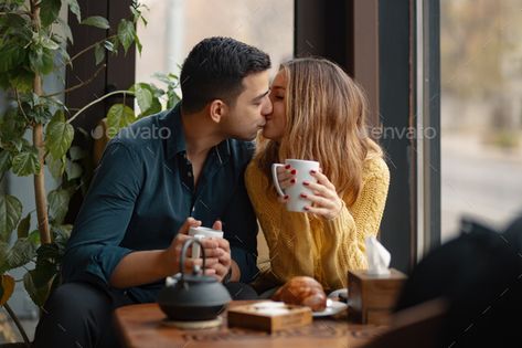 Young couple in love sitting in a cafe, drinking coffee by arthurhidden. Young attractive couple kissing on date in coffee shop. In love man and woman sitting in a cafe, drinking coffee#cafe, #drinking, #coffee, #sitting Eye Pressure, Does He Love Me, Signs He Loves You, Lifetime Movies, Three Fold, Love Me Do, Flirting Moves, Memes Sarcastic, Successful Relationships