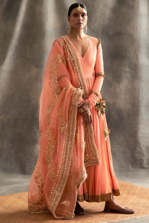 Featuring a peach angrakha kurta in cotton mulmul and lampi base with metallic godet and handmade tassels. It is paired with a matching silk organza dupatta having gota patti and dori hand embroidery.  FIT: Fitted at bust.  COMPOSITION: Cotton mulmul, Lampi, Silk organza.  CARE: Dry clean only. Peach Suit Indian, Peach Suit, Glitter Suit, Chanderi Dupatta, Silver Jacket, Elegant Maxi Dress, Amritsar, Anarkali Suit, Skirt And Blouse