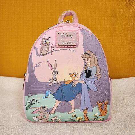 Fall In Love With This Super Cute Mini Backpack Featuring Aurora With All Of Her Woodland Friends! Make This The Perfect Gift For That Special Someone... Or Just Treat Yourself! * * * * Features * * * * * Height 10" * Width 5.5" * Length 8.5" * Top Handle 3" * Padded Adjustable Strap * Zip Closure * Gold Hardware * Faux Leather Exterior With Embroidered And Debossed Accents * 1 Large Front Zip Compartment ( Newer Style ) * 2 Side Pouches * Interior Is Pink Woodland Animal Print Fabric * Inside H Pink Mini Backpack, Lounge Fly, Loungefly Purse, Disney Backpack, Sleeping Beauty Aurora, Disney Now, Disney Adult, Cute Mini Backpacks, Kawaii Makeup