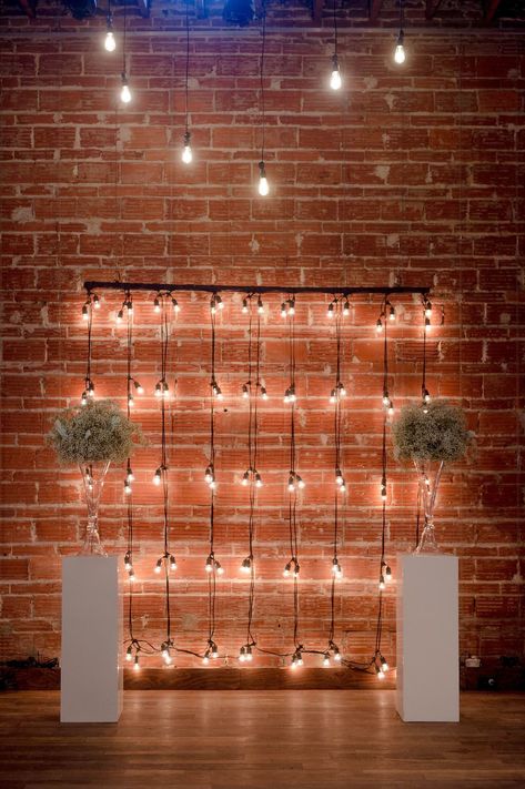 Exposed brick and industrial lighting ceremony backdrop in St. Pete #NOVA535 Brick Wall Photo Backdrop, Podcast Backdrop Ideas, Brick Photo Backdrop, Pod Room, Industrial Backdrop, Brick Backdrop, Brick Wall Decor, St Pete Wedding, Brick Wall Backdrop