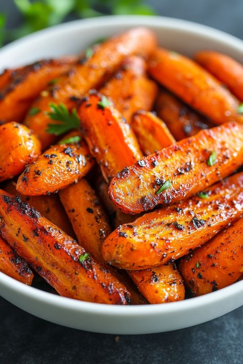 Roasted carrots garnished with herbs in a white bowl. Roast Carrot Recipes, Maple Glazed Roasted Carrots, Sides For A Roast Dinner, Roasted Glazed Carrots Oven, Fall Carrot Recipes, Maple Carrots Roasted, Glazed Carrots Recipe Oven, Asian Carrots, Thanksgiving Carrot Recipes