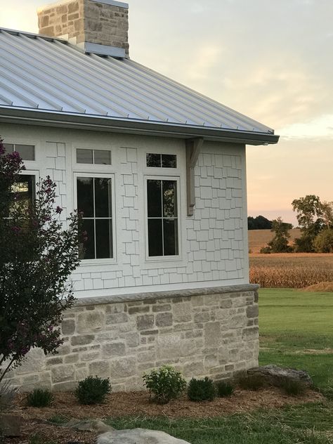 White House With Stone Wainscoting, White And Stone Farmhouse Exterior, Stone At Bottom Of House, Brick With Vertical Siding, Limestone On House Exterior, Stone Half Way Up Exterior, Ranch House With Stone And Siding, Stone On Front Of Garage, Cottage Exterior Stone