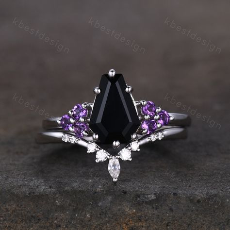 This is a beautiful black onyx and Amethsyt engagement ring set in sterling silver. Sterling Silver Black Onyx Engagement Ring Set Unique Coffin Shaped Ring Art Deco Moissanite Curved Wedding Band Amethyst Cluster Ring Unique coffin shaped ring, wedding ring, promise ring, anniversary gift. Engagement ring: Main Stone: 9x6mm coffin shaped black onyx. Side stone: 2mm amethyst Wedding band: Curved Moissanite This ring is marked S925/G10K/G14K I accept custom making order.Please contact me if you n Goth Ring Sets, Black And Purple Engagement Ring, Goth Engagement Rings Fairy, Black Coffin Engagement Ring, Coffin Wedding Rings, Coffin Shaped Ring, Coffin Ring Engagement, Black And Purple Wedding Rings, Goth Promise Ring