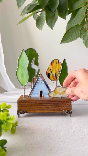 Stained Glass & Wood Artists on Instagram: "🌳🌲🏡🌲🌳The cabin scenes are one of our fave things to make … they just feel so peaceful. We’re gonna have some Little A-Frame in the Woods In tomorrow’s drop! Look for the timer In our stories! 🌳 . . #forestlovers #forestcore #cottagecore #cottagecoreaesthetic #cabindecor #homedecor #stainedglass #glassart #whimsicalart #intothewoods #wanderfolk #handmade #handmadeart #treehugger #treescape" Stained Glass Frames, Stained Glass Mosaic Art, Glass Painting Designs, Glass Mosaic Art, Cellar Door, Wood Artist, Stained Glass Diy, Cottage Core Aesthetic, Stained Glass Crafts