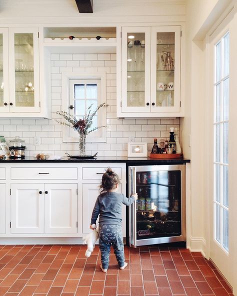 white cabinets with black countertops; white subway tile backsplash with darker colored grout Brick Floor Kitchen, Interior Brick, House Flipping, Brick Kitchen, Brick Tile, White Kitchens, Flooring Trends, Brick Flooring, Sunrooms