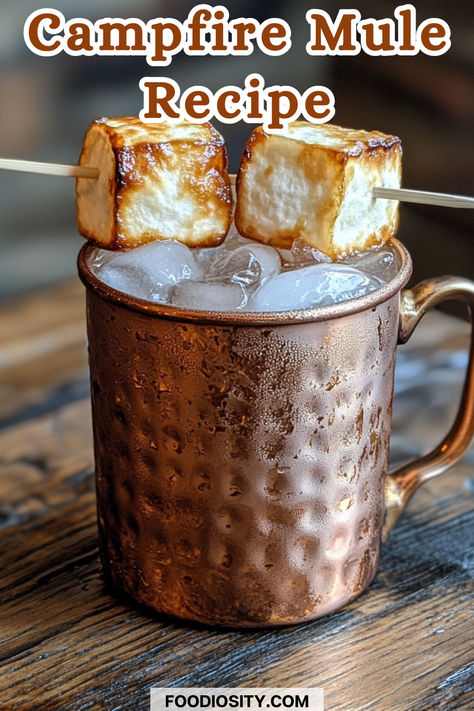 Cozy up with a Campfire Mule, the perfect cocktail for chilly nights by the fire! Its warm, smoky flavors are sure to enhance your outdoor experience, making it a must-try for your next gathering. Easy to prepare and full of rich, comforting notes. 
Click to get the full recipe and elevate your campfire vibes! Western Alcoholic Drinks, Smores Cocktail Whiskey, Campfire Old Fashioned Cocktail, Smoked Drink Recipes, Cowboy Cocktails, Mule Drink Recipes, Campfire Cocktails, Festive Holiday Cocktails, Whiskey Smash