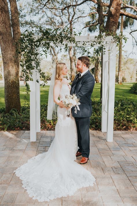 We love our simple white arbor draped in Smilax for Samantha & Max's elopement! Photo @madiemae.photo #ceremonydecor #ceremonyinspiration #ceremonyideas #weddingceremonydesign #ceremonydetails #ceremonystyling #aislestyle #aisleperfect #ceremonydesign #outdoorceremony #weddingarch #arbor #weddingarbor #weddingbackdrop #ceremonyarch #elopementceremonyinspo #elopementarbor #elopementideas #elopementinspo #simpleelopementflorals #floridaelopements Wedding Draping, Old Oak Tree, Wedding Arbour, Ceremony Design, Intimate Wedding Ceremony, Elopement Ceremony, Ceremony Inspiration, Ceremony Arch, Arbor