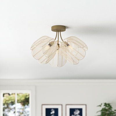 This 3-light semi-flush mount brings a bit of cottage-inspired floral charm to any room in your home thanks to its angled, bell-shaped white rattan shades. The fixture is crafted from iron with a brushed gold finish for a glam vibe we're all about. Hidden with the open shades are three 40W max bulbs (sold separately) that send a dimmable ambient glow throughout your space. And, with a hanging height of approximately 11.5", this mount is a great addition to space-conscious areas with lower ceilin Nursery Light Fixture, Boho Light Fixture, Laundry Room Lighting, Shade House, Living Room Light Fixtures, Metal Ceiling Lighting, Nursery Lighting, Rattan Shades, Entryway Lighting