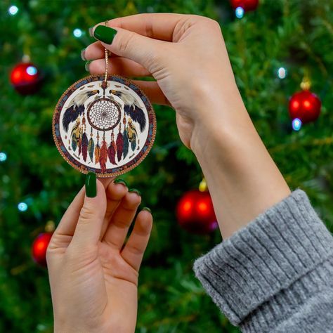 Indigenous Peoples of North America Ceramic Holiday Ornament Honoring Native American, First Nations, Inuit, Métis Heritage Indigenous Peoples of North America Ornament Title: "Indigenous Peoples of North America Ceramic Ornament - Dreamcatcher Design with Traditional Symbols - Unique Holiday and Year-Round Decor" Description: Celebrate the rich cultural heritage of Indigenous Peoples of North America with this beautifully crafted ceramic ornament. At its heart, the design features a traditional dreamcatcher, intricately woven with vibrant patterns inspired by Indigenous beadwork. Surrounding the dreamcatcher are symbolic elements such as feathers, eagles, and wolves, representing the deep connection to nature and the spiritual world. The vibrant colors and detailed patterns reflect the di Dreamcatcher Design, Native American Symbols, American Symbols, Holiday Ornament, Round Decor, Cultural Heritage, Ceramic Ornaments, Holiday Ornaments, Red Christmas