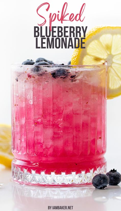 A glass full of spiked blueberry lemonade is shown, the glass is ornate, and has a lemon wheel on the edge and blueberries around it. This is all on a white counter. Blueberry Drink, Blueberry Drinks, Lemonade Juice, Lemonade Drink, Homemade Lemonade Recipes, Coctails Recipes, Blueberry Syrup, Blueberry Lemonade, Summer Drink Recipes