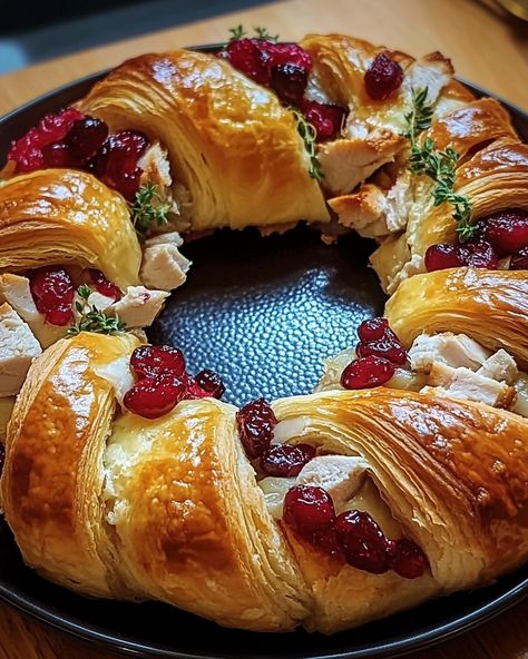 Savory Turkey and Cranberry Crescent Ring 🦃 Ingredients: - 2 cans (8 oz each) refrigerated crescent rolls - 2 cups cooked turkey, chopped - 1/2 cup cranberry sauce - 1 cup shredded mozzarella or cheddar cheese - 1/4 cup mayonnaise - Fresh thyme (optional for garnish) Instructions: 1. Preheat your oven to 375°F (190°C). Lightly grease a round pizza pan. 2. Unroll crescent dough and separate triangles. Arrange them in a circular pattern on the pizza pan with the wide ends overlapping in the c... Thanksgiving Crescent Ring, Home Meals, Crescent Dough, Pan Pizza, Cranberry Sauce, Cooking Turkey, Shredded Mozzarella, Crescent Rolls, Dinner Party